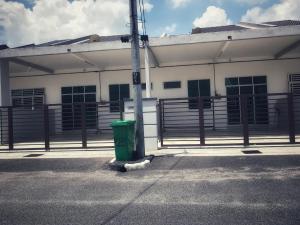 a green trash can in front of a building at Arsyad Homestay Changlun in Changlun