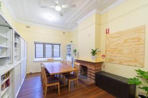 a dining room with a table and a fireplace at myOZexp Aberdeen Lodge in Perth