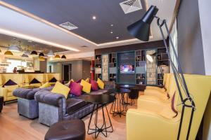 
a living room filled with furniture and a tv at Premier Inn Dubai Investments Park in Dubai
