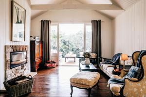 a living room with a couch and a fireplace at Nightcap Ridge - Byron Bay Hinterland in Dorroughby