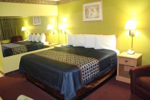 a hotel room with two beds and a chair at Hutchinson Inn in Hutchinson +27 photos