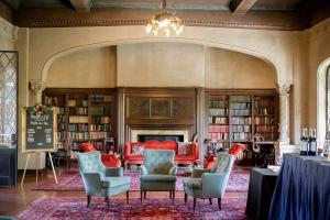 a library with chairs and a table and bookshelves at Berkeley City Club Hotel in Berkeley