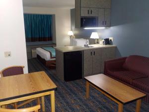a hotel room with a kitchen and a living room at MJ INN and SUITES in Marienville