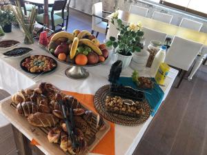 a table with many different types of food on it at Hotel Hugo in Altınoluk