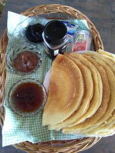 a basket with pancakes and sauce on a table at Apartments Sharka in Děčín