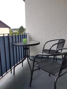 a small table and two chairs on a balcony at Apartment Alt-Refrath in Bergisch Gladbach