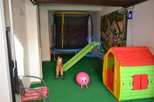 una sala de juegos con un tobogán y un parque infantil en Gabizz Apartments, en Constanţa