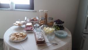 a table with desserts and other foods on it at Venustas in Lampedusa