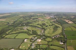 an aerial view of green fields and houses at Bowood Park Hotel in Camelford