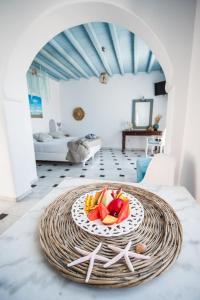 a plate of fruit on a table in a room at Amazing View Hotel Apartments in Agios Stefanos