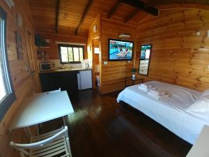 a bedroom with a bed in a wooden cabin at Assaf's place - המקום של אסף in Aẖihud +83 photos