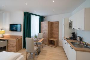 a kitchen and dining room with a table and a desk at Apartment Düsseldorf Nord in Düsseldorf