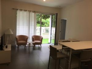 a dining room with chairs and a table and a window at Residence vue de reve - 1 ere ligne de plage in Arcachon +2 photos