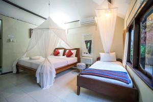 Säng eller sängar i ett rum på Manuaba Inn