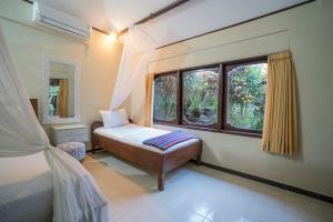Säng eller sängar i ett rum på Manuaba Inn