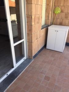 a patio with a door and a tile floor at M&Y S HOUSE vicino alle spiagge Lavagna in Lavagna