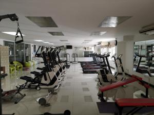 a gym with rows of treadmills and exercise bikes at Sirapa Resident in Chachoengsao