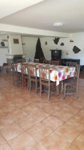 a dining room with a table with chairs and a christmas tree at La Curtea Argeseana in Valea Iasului +30 photos
