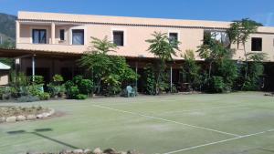 a tennis court in front of a building at A Casa di Nené in Palinuro