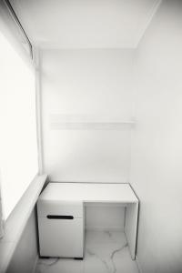 a white desk in a room with a window at Rika apartments in Chernivtsi