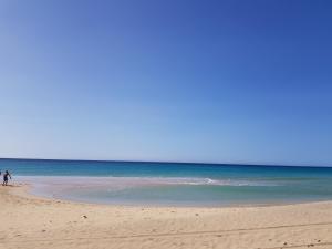 a couple of people walking on the beach at Loft del Mar 2 Jandia in Playa Jandia