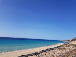 a group of people on a beach near the ocean at Loft del Mar 2 Jandia in Playa Jandia
