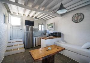 a kitchen with a couch and a table in a room at Windmill Arades suite in Apollonia
