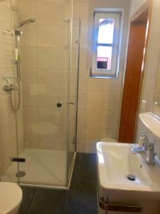 a bathroom with a shower and a sink at Ferienhaus "Ahle Schinn" in Bad Sooden-Allendorf +46 photos