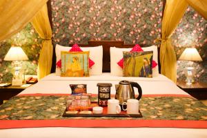 a hotel room with a bed with a tray of food at The Grand Imperial - Heritage Hotel in Agra