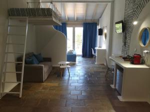 a room with a loft bed and a living room at Pietra mare vourvourou in Vourvourou
