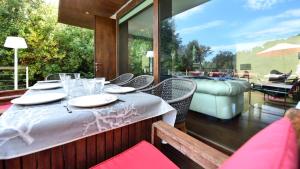 a dining room with a table and a large window at Villa Begur Hideaway con piscina privada in Begur