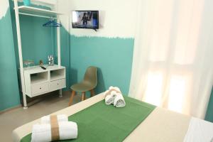 a bedroom with a bed with a sink and a mirror at BeachSide Rooms & Suites in San Vito lo Capo +63 photos