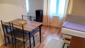 a small room with a table and chairs and a couch at Apartment Mica Old Town in Sarajevo
