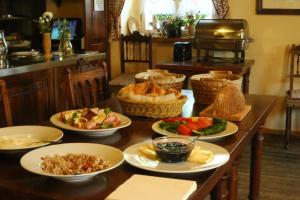 a table with many plates of food on it at U Bílého koníka in Kostelní Bříza