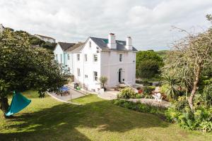 a large white house with a yard at Merchants House in Salcombe