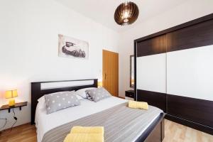 a bedroom with a large bed with two yellow chairs at Kalauz Rooms in Lozovac