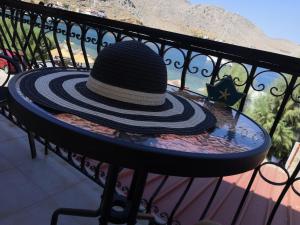 a hat sitting on a table on a bench at Korali in Symi