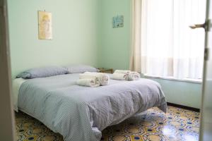 a bedroom with a bed with towels on it at Le Vigne - Villa overlooking Etna in Adrano
