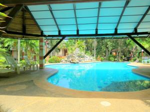 a swimming pool in a resort with blue water at ALONALAND RESORT in Panglao Island