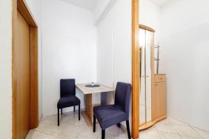 a small table and two chairs in a room at Kalauz Rooms in Lozovac