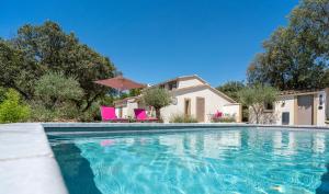 a swimming pool in front of a house at Mas la Chêneraie Lourmarin - Au calme, à 10 mn du centre ville à pied in Lourmarin
