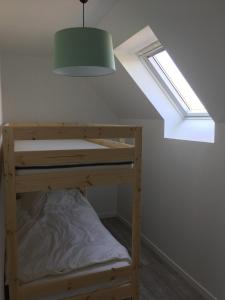 a bunk bed in a room with a window at TANTE LICHE in Penmarch