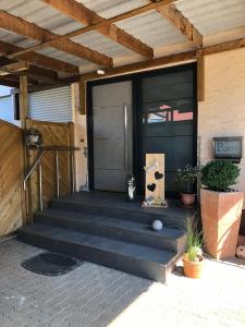 a front door of a house with stairs and plants at Zum Schnatz in Willingshausen