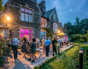 a group of people standing in front of a house at Kotel Windermere in Windermere