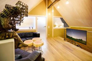 a living room with a couch and a tv at Blaues Haus in Monschau