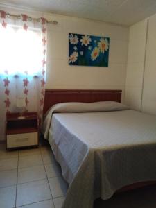 a bedroom with two beds and a window at Casa Vacanze Margherita - Sasso di Castalda in Sasso di Castalda