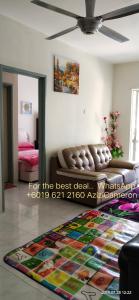 a living room with a couch and a rug on the floor at Cameron Highlands Muslim Apartment by AziziCameron in Cameron Highlands