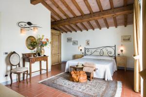 a bedroom with a bed and a table and a chair at Fattoria Pogni in Marcialla +73 photos