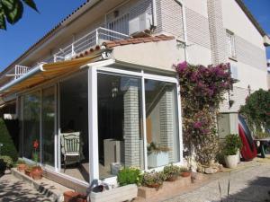 ein Haus mit großen Glastüren und Blumen darauf in der Unterkunft Casa Sant Antoni Maria Claret in Cambrils
