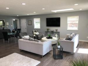 a living room with two couches and a tv at Liberty House in Bethany